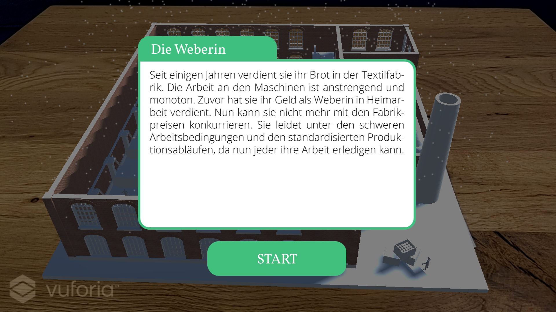 Screenshot of yARn that shows a 3D rendered factory projected on a wooden table from the perspective of the weaver. In the foreground a short description of the role of the weaver and a 'start' button are displayed.